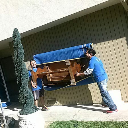 Crystal Coast Moving carrying a table