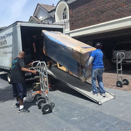 Crystal Coast Moving loading furniture into a truck