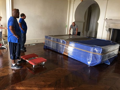 Crystal Coast Moving team preparing a bedroom for move